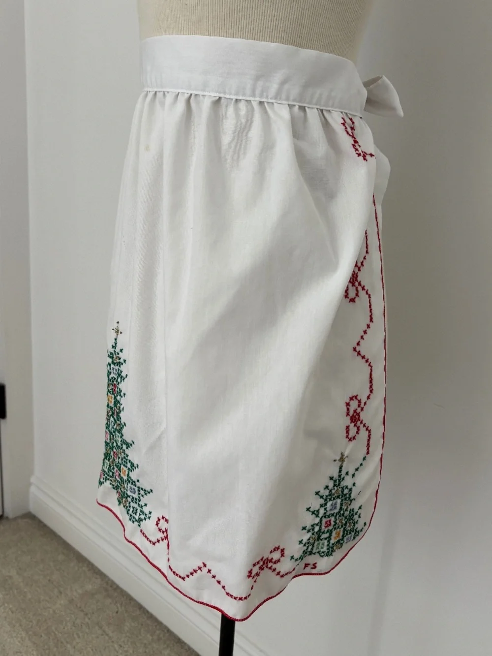 Vintage white half apron featuring hand-stitched cross-stitch Christmas trees